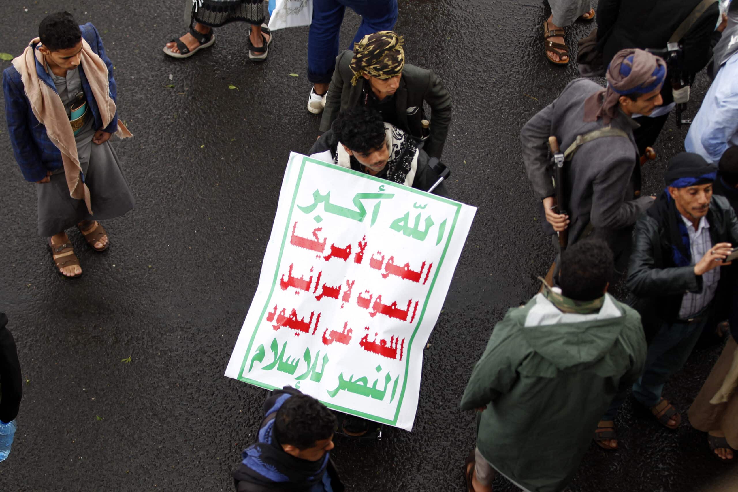 Yemeni supporters of the Huthi movement hold a placard reading in Arabic "Death to America, Death to Israel, Damn the Jews, Victory to Islam" during a demonstration in Sanaa on January 6, 2020 to denounce the US killing of Iranian major general Qassem Soleimani and Iraqi paramilitary chief Abu Mahdi al-Muhandis. Soleimani and al-Muhandis were killed in a US drone strike near Baghdad's international airport, sparking fury in Iran and Iraq. (Photo by MOHAMMED HUWAIS / AFP)