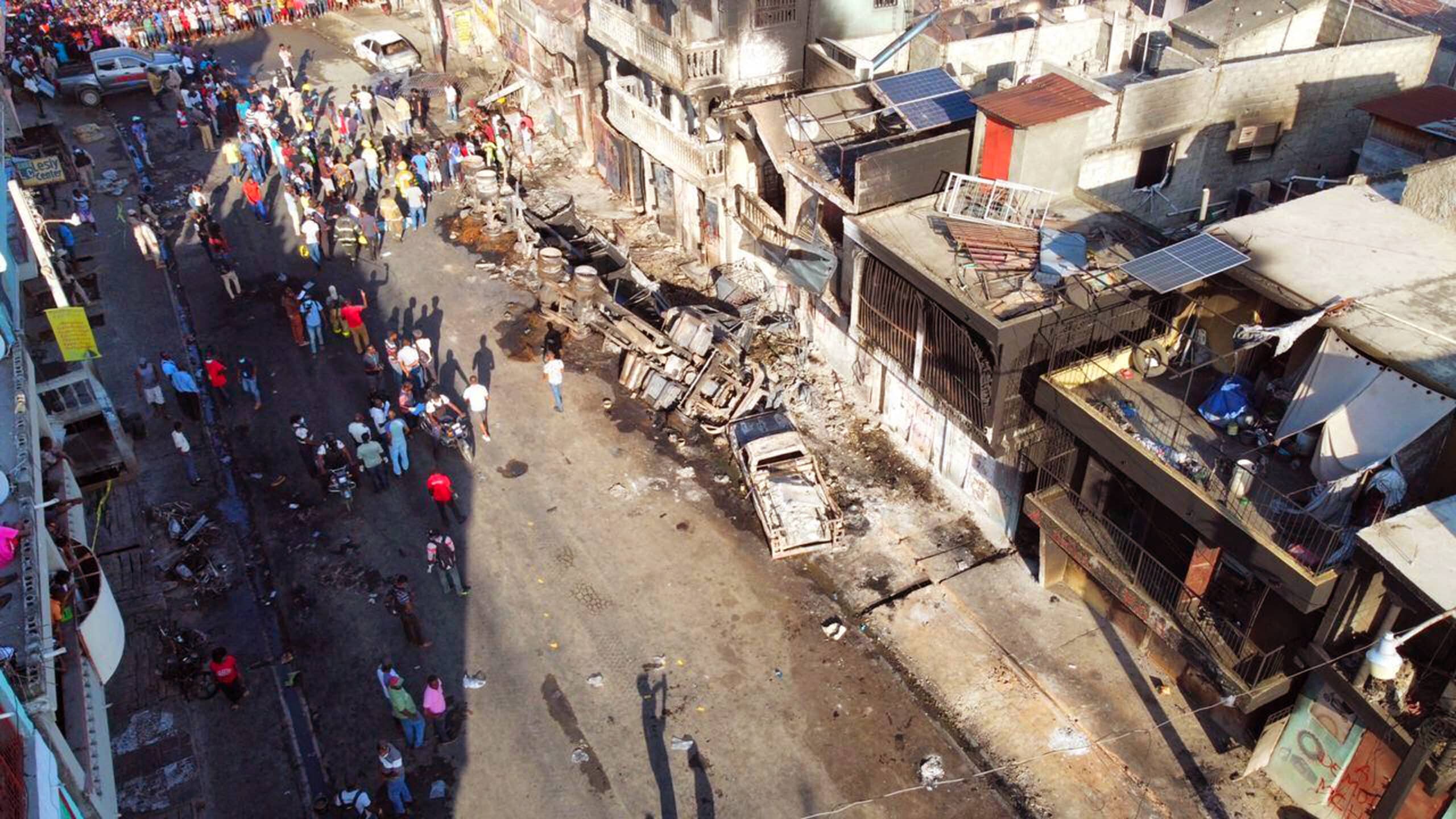 This image courtesy of the Communication Department of the Cap-Haitien City Hall shows the remains of a gas tanker truck after it exploded in Cap-Hatien, Haiti, December 14, 2021. At least 62 people were killed when a gas tanker truck exploded in the Haitian city of Cap-Haitien on Tuesday morning, a local official said, with overwhelmed medics saying the toll was feared to rise. The blast is the latest disaster to hit the poverty-wracked Caribbean nation, where violent gangs have triggered crippling fuel shortages by choking off supply, and the president's assassination five months ago has yet to be elucidated. (Photo by Handout / Cap-Haitien City Hall / AFP) 