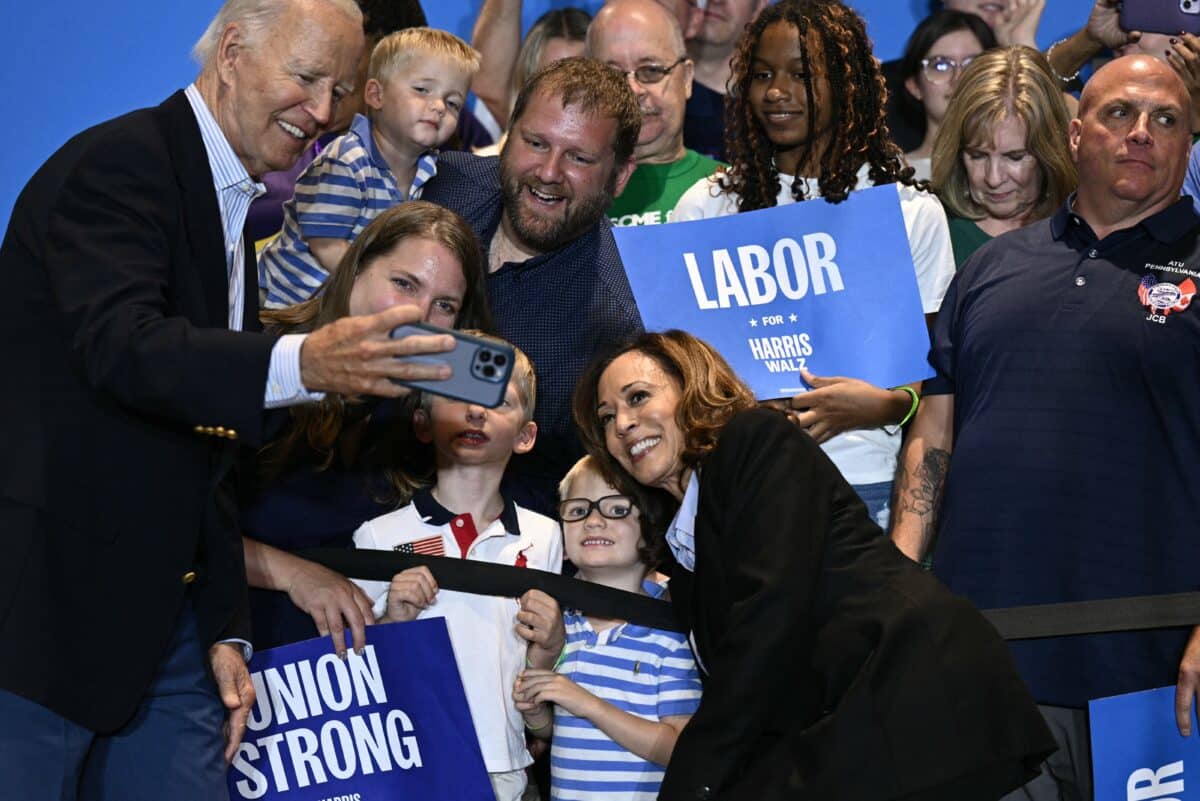 US President Joe Biden (L) and US Vice President and Democratic presidential candidate Kamala Harris pose for a selfie with supporters at the end of a campaign rally at the International Brotherhood of Electrical Workers (IBEW) Local 5 in Pittsburgh, Pennsylvania, on September 2, 2024. 