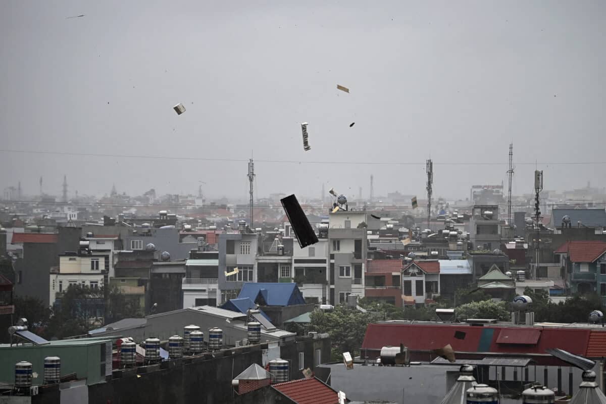 Debris flies in the air as heavy rain and high winds from Super Typhoon Yagi impact Hai Phong on September 7, 2024. - Super Typhoon Yagi made landfall on northern Vietnam's Hai Phong and Quang Ninh provinces on September 7, bringing wind speeds exceeding 149 kilometres (92 miles) per hour, state media said. (Photo by NHAC NGUYEN / AFP)