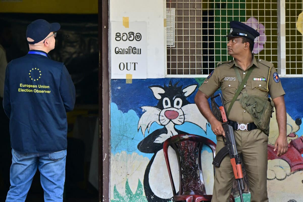 An election observer (L) from the European Union is seen at a polling station during voting in Sri Lanka's presidential election in Colombo on September 21, 2024. - Cash-strapped Sri Lanka began voting for its next president September 21 in an effective referendum on an unpopular International Monetary Fund austerity plan enacted after the island nation's unprecedented financial crisis.