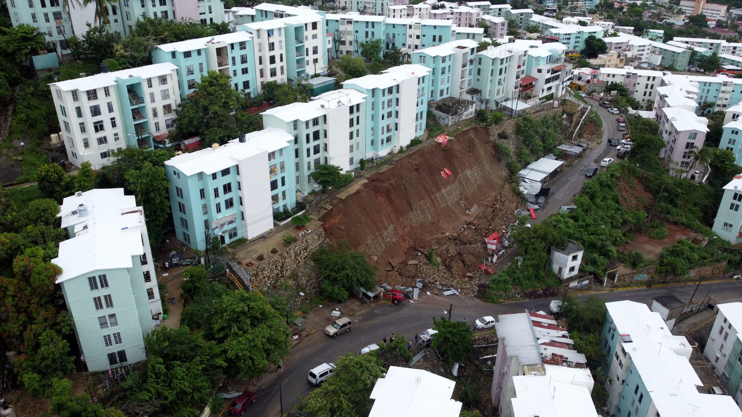 Buildings at risk of collapse after a retaining wall failed due to heavy rains following Hurricane John are pictured in Acapulco, Guerrero State, Mexico, on September 28, 2024. - Hurricane John, which made landfall twice in the Mexican Pacific, has left eight dead, all in the Mexican state of Guerrero (south), the most affected by the phenomenon, the Mexican government reported Saturday. (Photo by Francisco ROBLES / AFP)