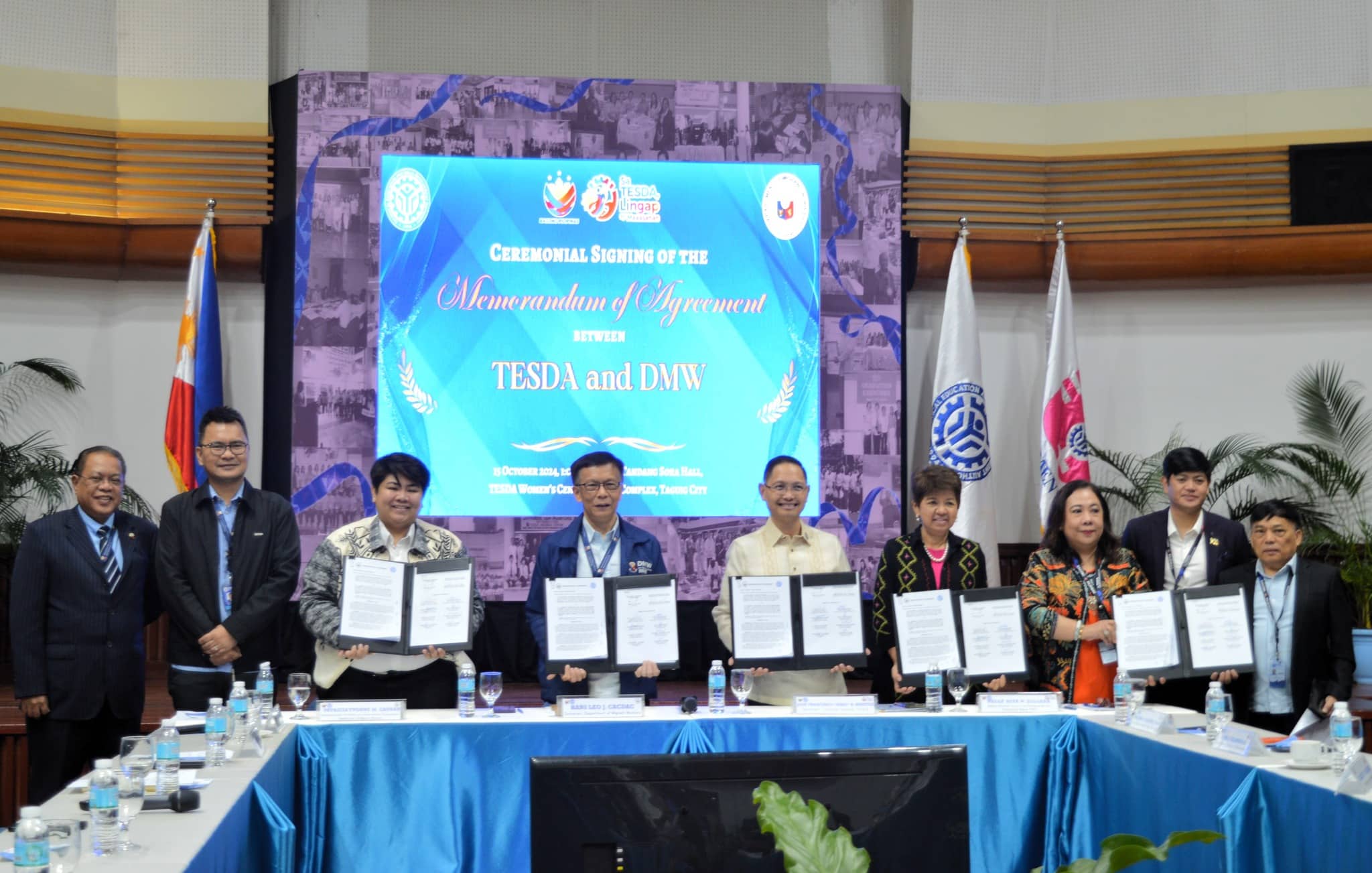 The Department of Migrant Workers (DMW) and the Technical Education and Skills Development Authority (TESDA) officials inked a memorandum of agreement at the TESDA office in Taguig City on Tuesday (Oct. 15, 2024). The agreement aims to enhance the skills and employability of the overseas Filipino workers. (Photo courtesy of DMW)