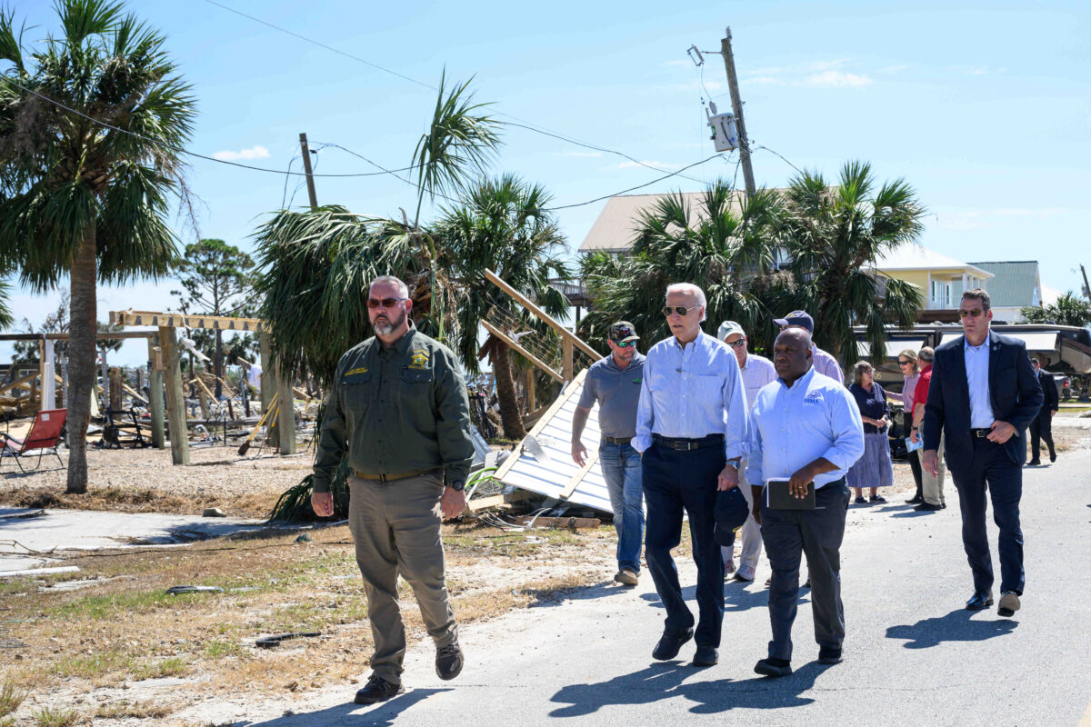 US President Joe Biden (2L) participates in a tour and briefing of an area affected by Hurricane Helene in Keaton Beach, Florida, on October 3, 2024. - Also pictured are US Senator Rick Scott (L), Republican of Florida, and FEMA Deputy Administrator Erik Hooks.