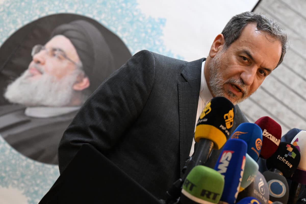 Iranian Foreign Minister Abbas Araghchi speaks to the press, in front of the portrait of slain Lebanese Hezbollah leader Hassan Nasrallah, after meeting with Syrian officials at the Iranian embassy in Damascus on October 5, 2024.