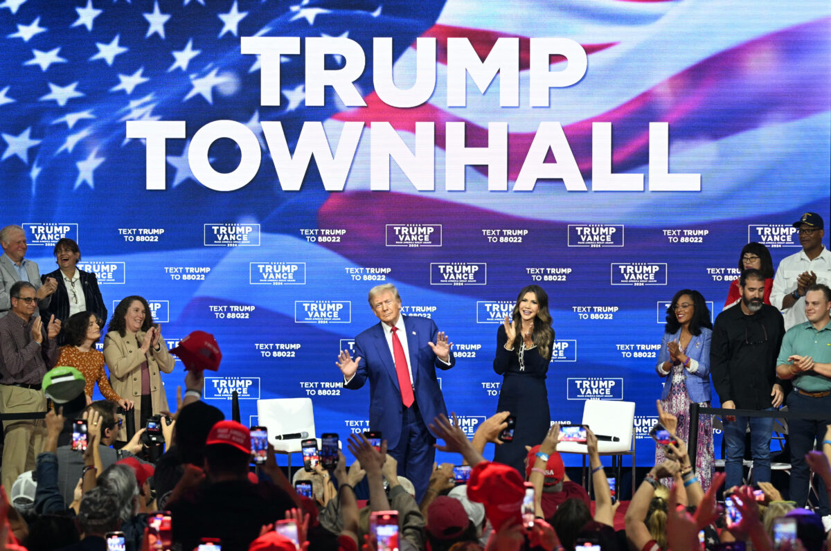 Former US President and Republican presidential candidate Donald Trump, with moderator and South Dakota Governor Kristi Noem (R), arrives for a town hall at the Greater Philadelphia Expo Center and Fairgrounds in Oaks, Pennsylvania, on October 14, 2024.