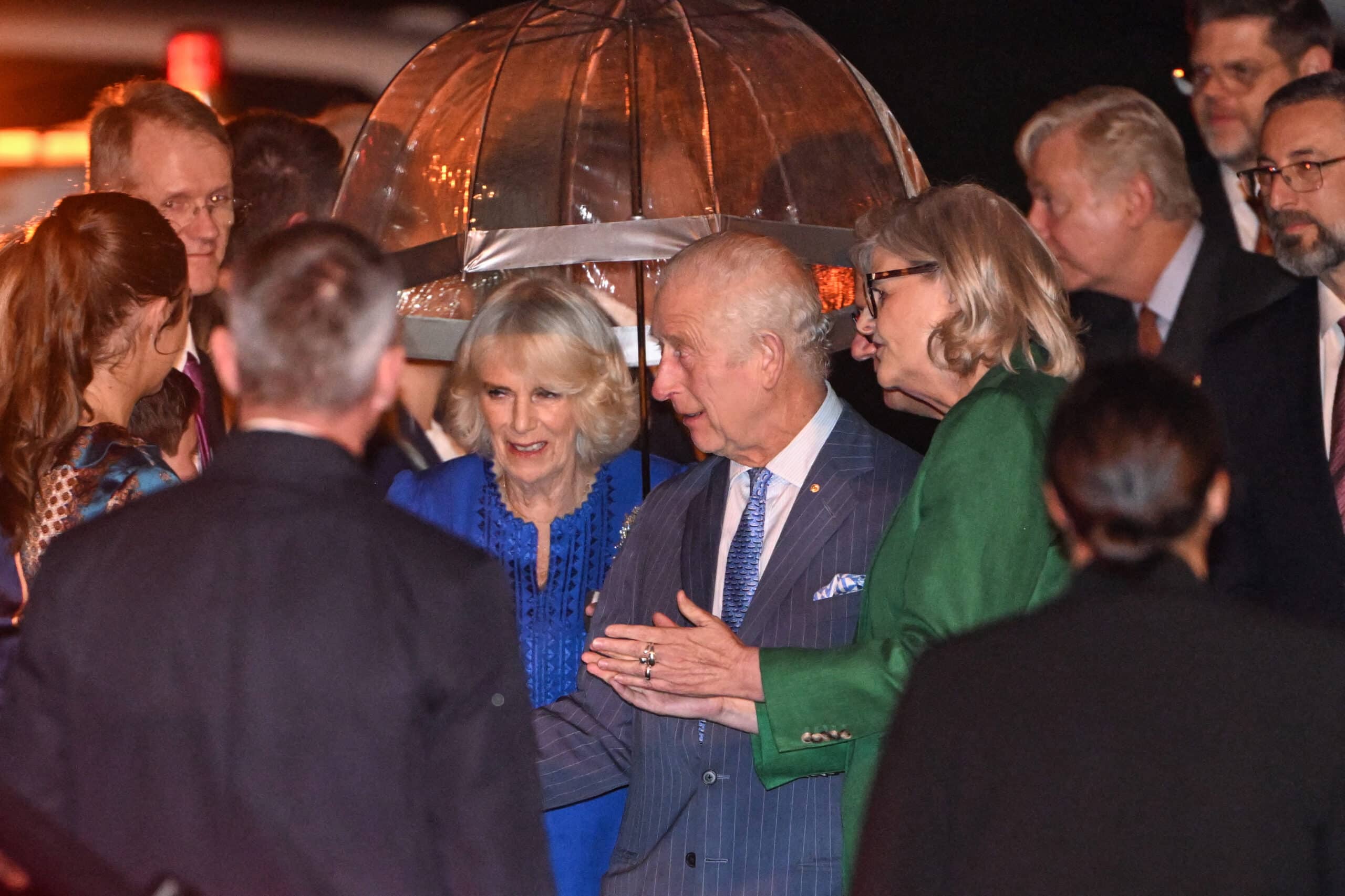 Britain's King Charles III (center R) and Queen Camilla (center L) are greeted upon their arrival at Sydney International Airport in Sydney on October 18, 2024, for a six-day royal visit to Sydney and Canberra. (Photo by Saeed KHAN / AFP)