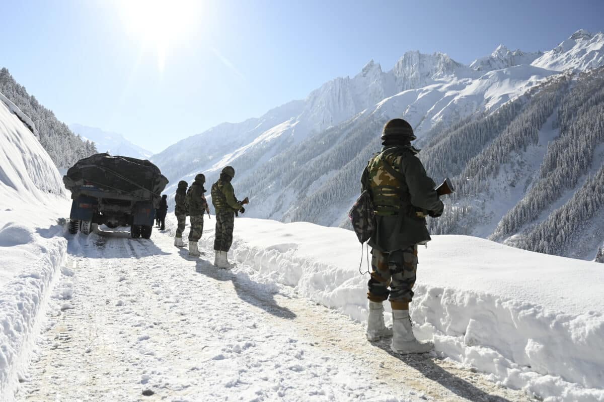 Indian army soldiers walk along a road near Zojila mountain pass that connects Srinagar to the union territory of Ladakh, bordering China on February 28, 2021. - India said on October 21, 2024 it had struck an agreement with neighbour China for military patrols in highly contested border zones, stalled since their rival armies clashed in 2020.