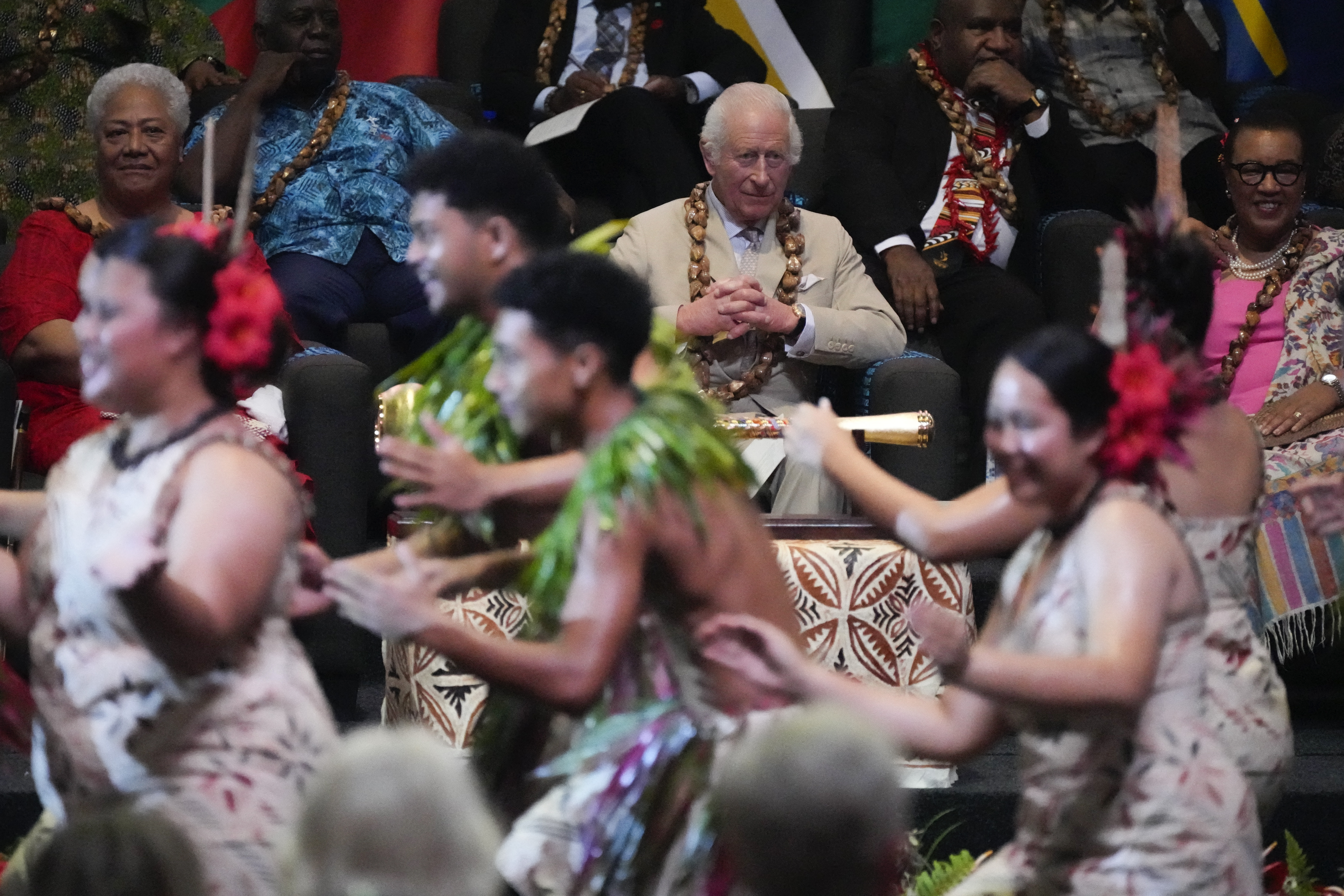 Britain's King Charles III (C) watches as dancers perform during the opening ceremony for the Commonwealth Heads of Government Meeting (CHOGM) in Apia, Samoa, on October 25, 2024. (Photo by Rick Rycroft / POOL / AFP)