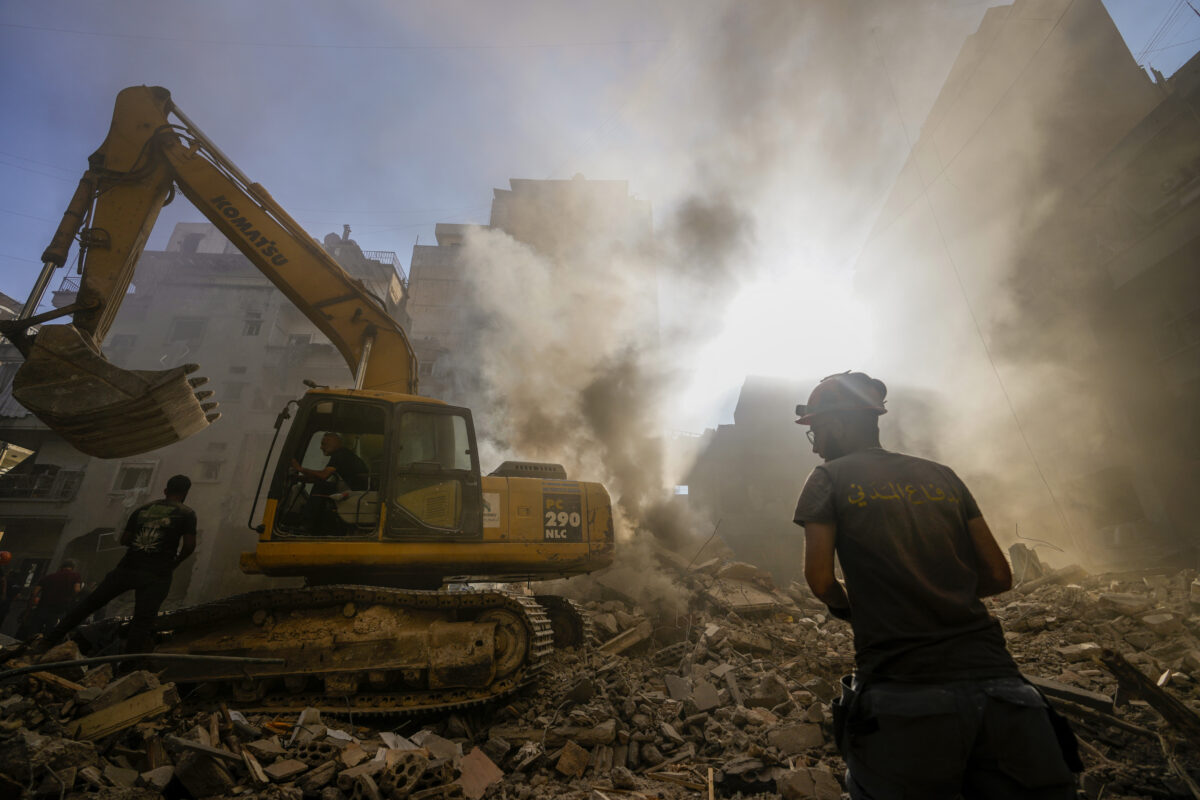 Rescue workers search for victims at the site of Thursday's Israeli airstrike in Beirut, Lebanon, Friday, Oct. 11, 2024. (AP Photo/Hassan Ammar)