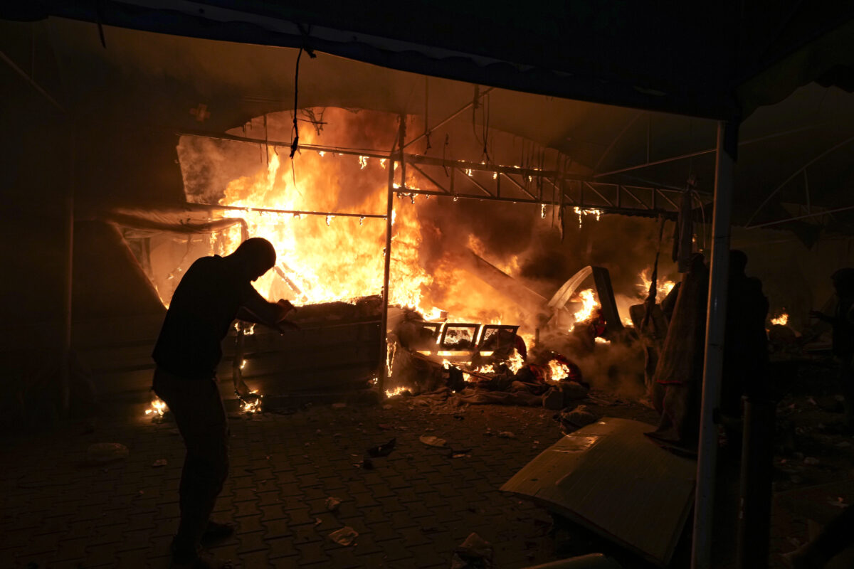 Palestinians react to a fire after an Israeli strike hit a tent area in the courtyard of Al Aqsa Martyrs hospital in Deir al Balah, Gaza Strip, Monday, Oct. 14, 2024.