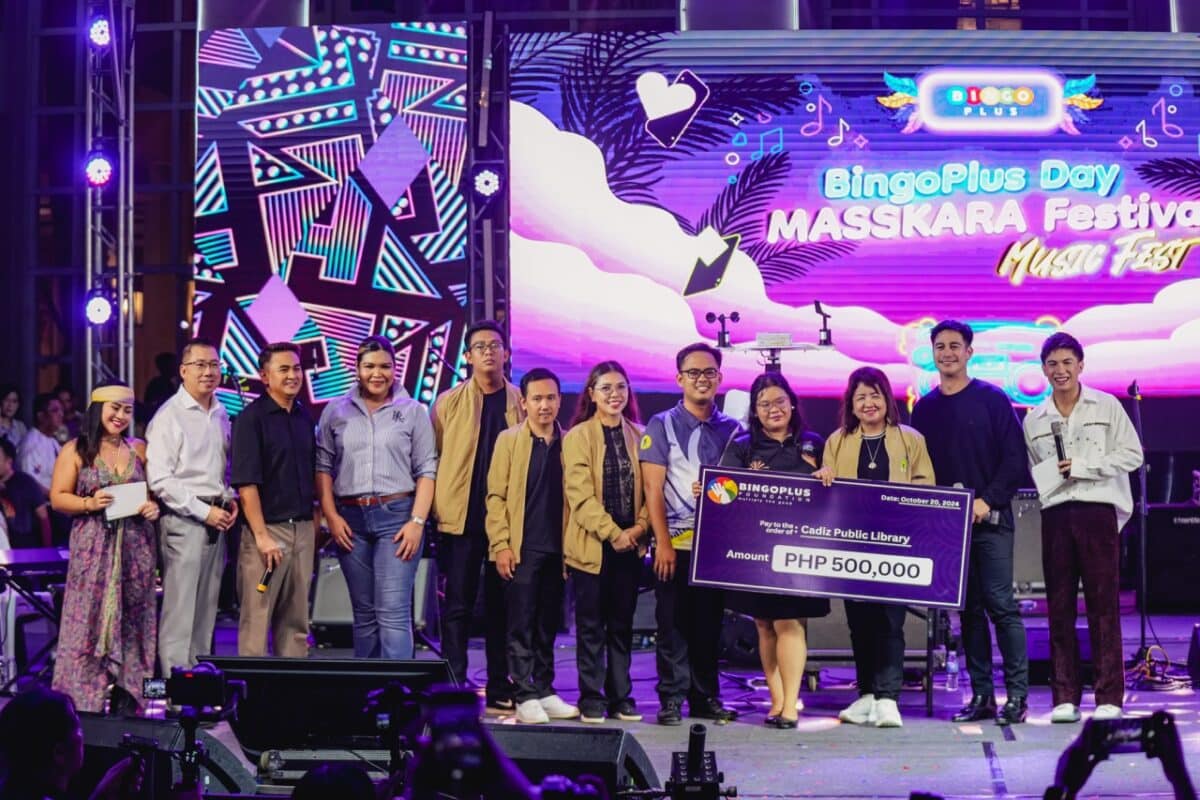 Cadiz Public Library receiving Php 500,000 mock cheque with BingoPlus executives and endorser during the BingoPlus Day Masskara Music Festival 2024.