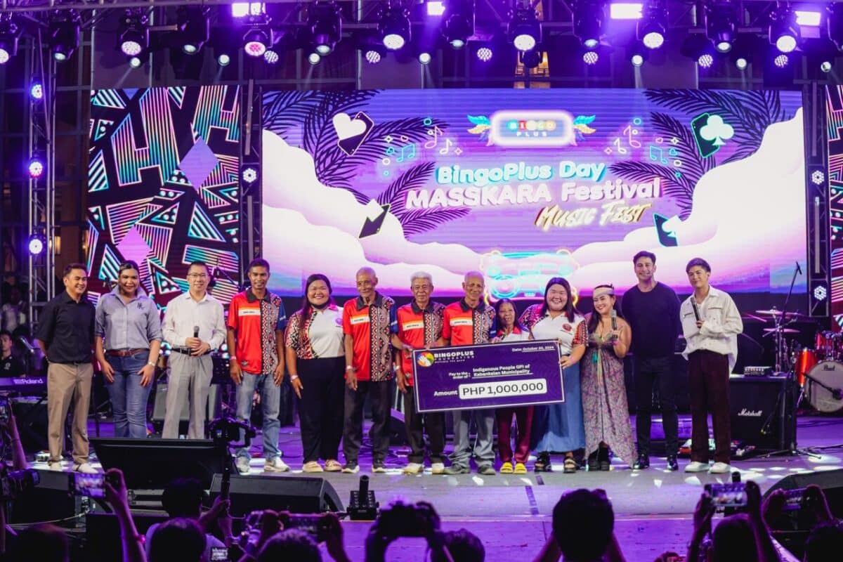 Indigenous People (IP) of Kabankalan City, Negros Occidental receiving Php 1,000,000 mock cheque with BingoPlus executives and endorser during the BingoPlus Day Masskara Music Festival 2024.