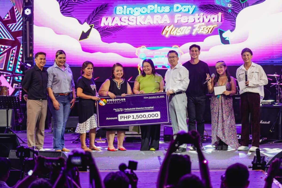 Valladolid District Hospital receiving Php 1,500,000 mock cheque with BingoPlus executives and endorser during the BingoPlus Day Masskara Music Festival 2024.