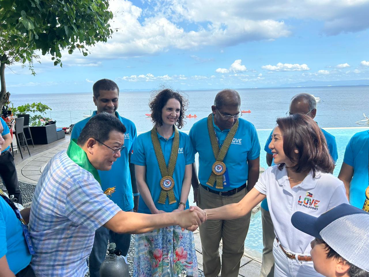 Ambassador of Thailand to the Philippines Tull Traisorat and Tourism Secretary Christina Garcia Frasco happily shake hands after the  launching of the first-ever Philippine Dive Experience in Anilao, Batangas, on November 28, 2024. (Photo courtesy of Luisa Cabato/INQUIRER.net)