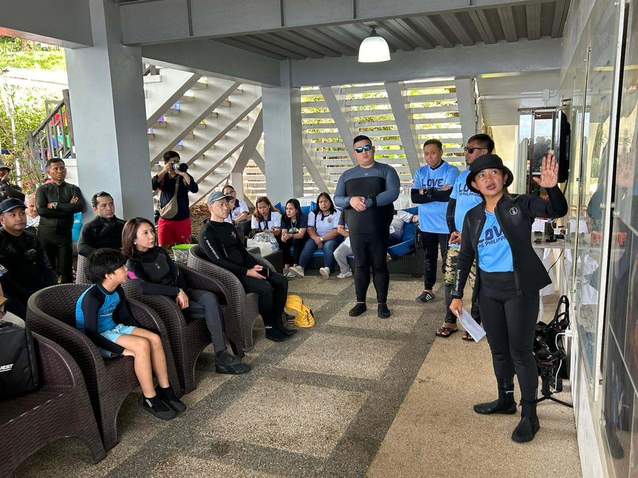 Tourism Secretary Christina Garcia Frasco and local and foreign guests undergo a quick briefing prior to their dive at Anilao, Batangas, on November 28, 2024. (Photo courtesy of Luisa Cabato/INQUIRER.net)