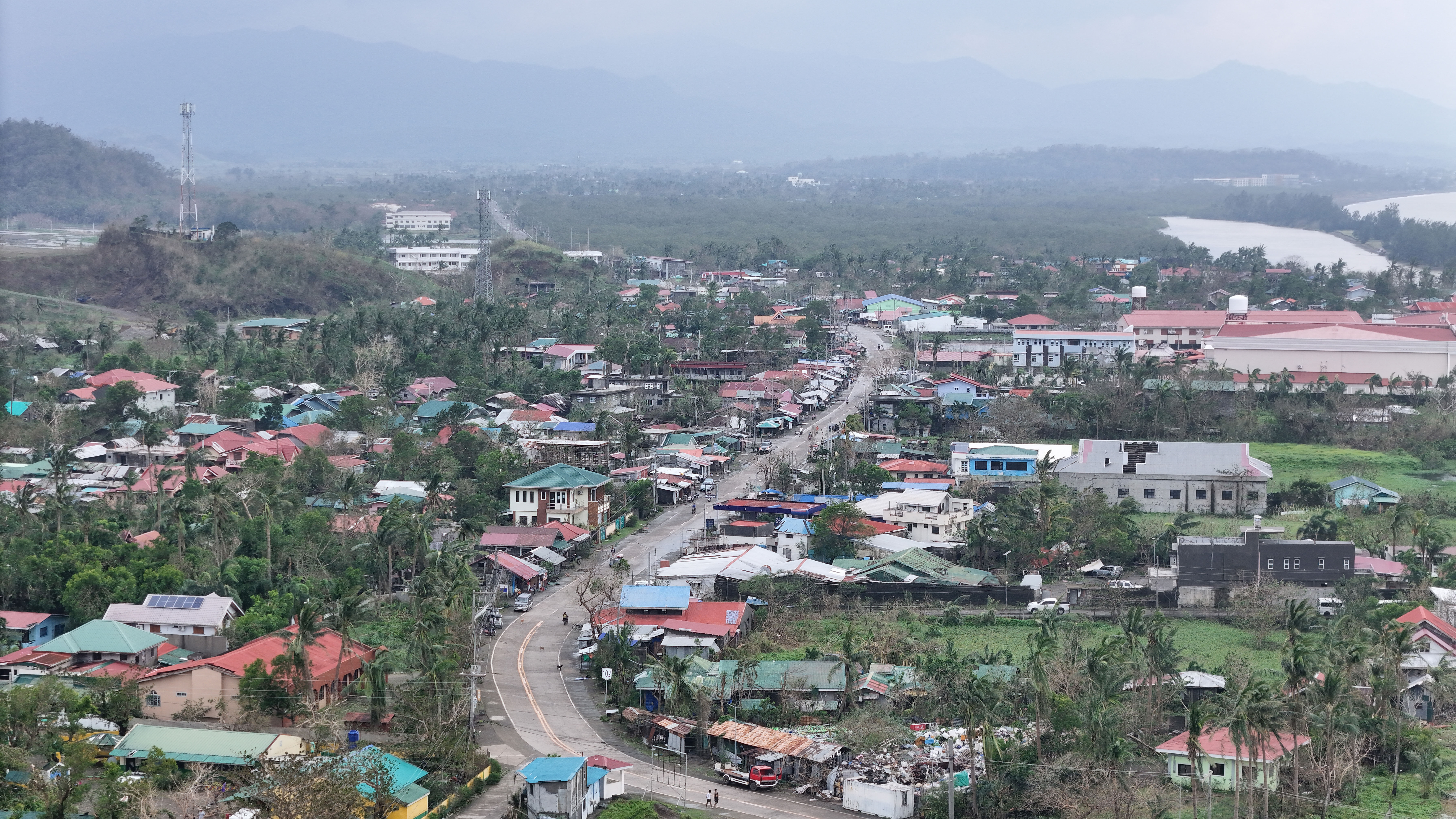 An aerial photo shows houses with blown-up roofs in Santa Ana town, Cagayan province, north of Manila on November 8, 2024, following Typhoon Yinxing hitting the province. (Photo by John DIMAIN / AFP)