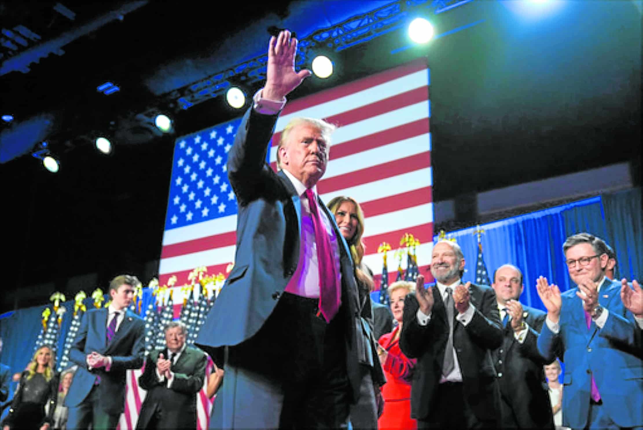 IT’S BEEN A GOOD RUN Donald Trump, with former firstlady Melania Trump, waves at supporters during an election night watch party at the Palm Beach Convention Center in Florida on Wednesday.