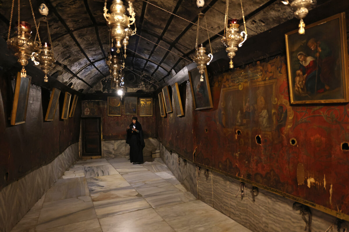 A Christian worshipper visits the Church of the Nativity in the biblical city of Bethlehem, in the occupied West Bank, on December 17, 2024. - On Bethlehem's Manger Square, Christmas decorations and pilgrims are notably absent for a second wartime festive season in the Israeli-occupied West Bank city. Violence across the Israeli-occupied West Bank has surged since the war in Gaza broke out on October 7 last year, but Bethlehem has remained largely quiet, even though the fighting has taken an overall toll on the now predominantly Muslim city. (Photo by AHMAD GHARABLI / AFP)