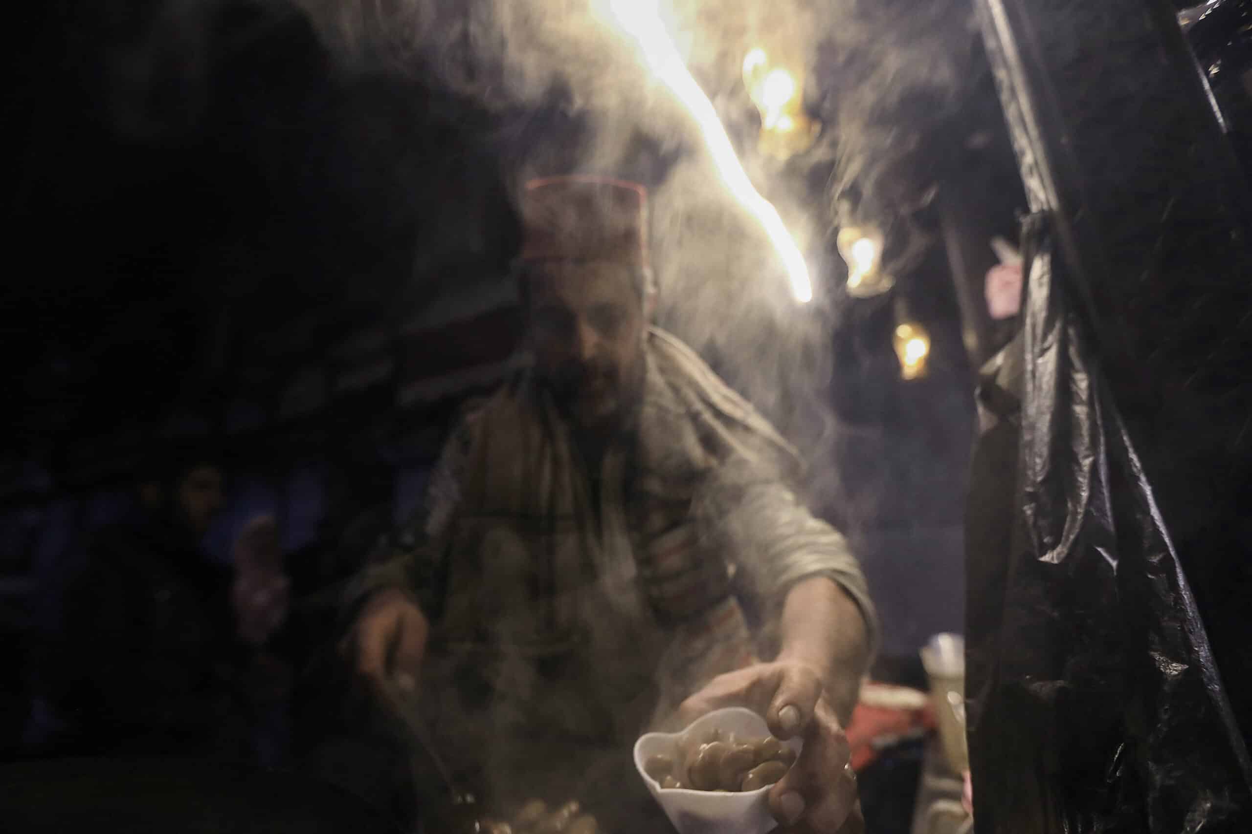 A vendor fills an order at his stall selling a traditional fava bean dish on a street in Damascus on December 25, 2024. (Photo by Bakr ALKASEM / AFP)