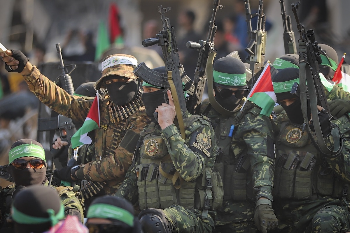 PHOTO: Hamas fighters on a pickup truck FOR STORY: Israelis, Palestinians rejoice as more hostages, prisoners freed