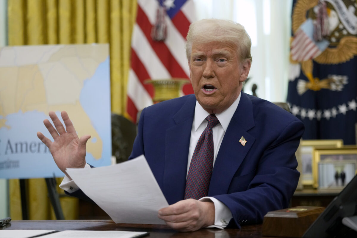 President Donald Trump speaks to reporters in the Oval Office of the White House, where he signed an executive order, Thursday, Feb. 13, 2025, in Washington.