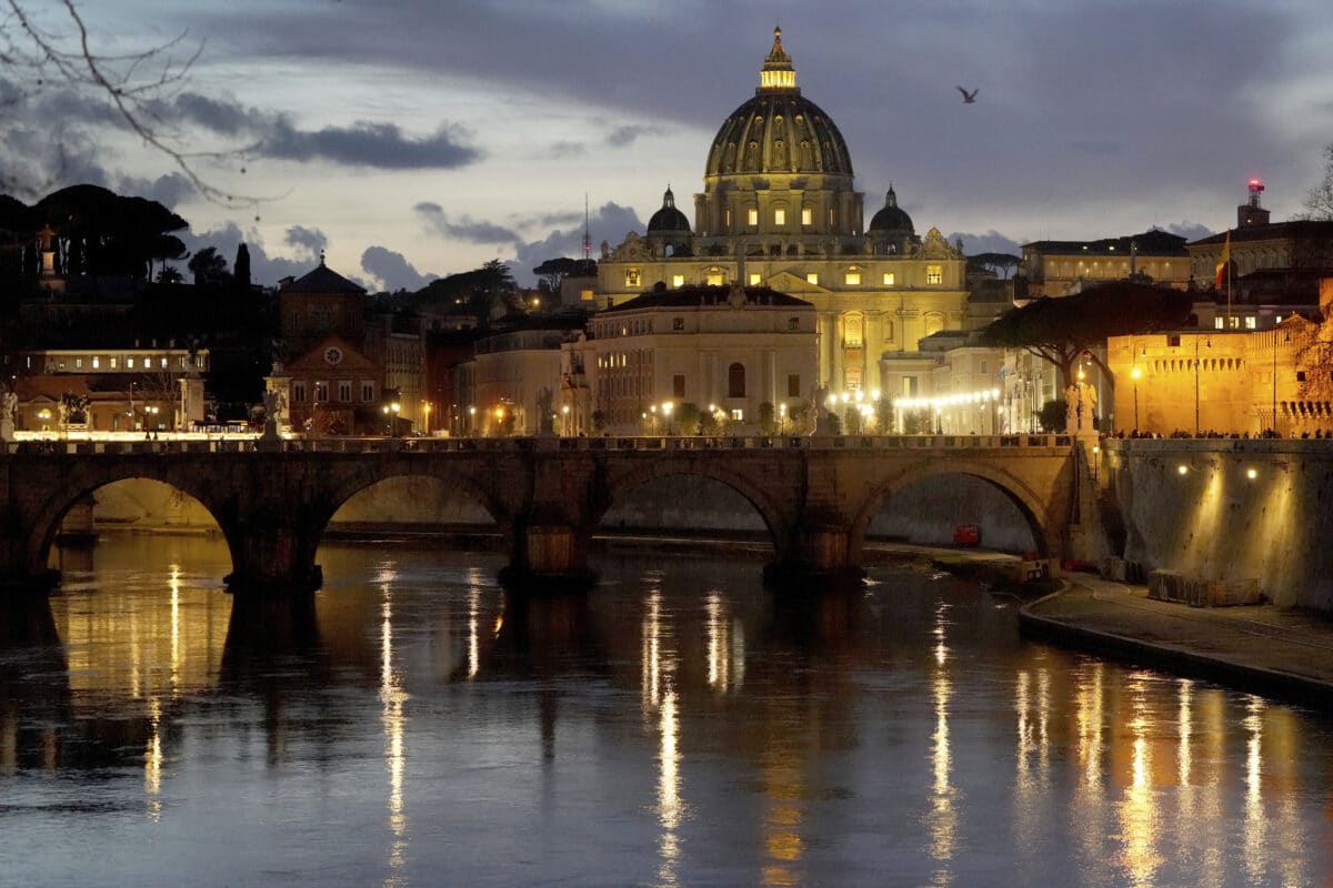 St. Peter's Basilica at The Vatican is seen at dusk across the river Tiber in Rome, Italy Friday, Feb. 28, 2025.