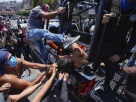 PHOTO: A woman suspected in the kidnapping and killing of an 8-year-old girl, is dragged out of a police vehicle by a mob in Taxco, Mexico, Thursday, March 28, 2024.